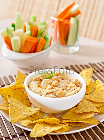 Healthy homemade  hummus with vegetables, olive oil and pita chips