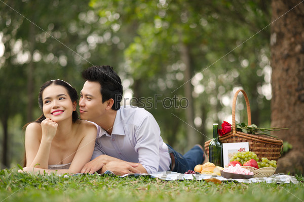 Attractive young people resting together on picnic
