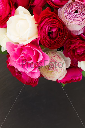 bunch of fresh pink  ranunculus and rose flowers  close  on black background