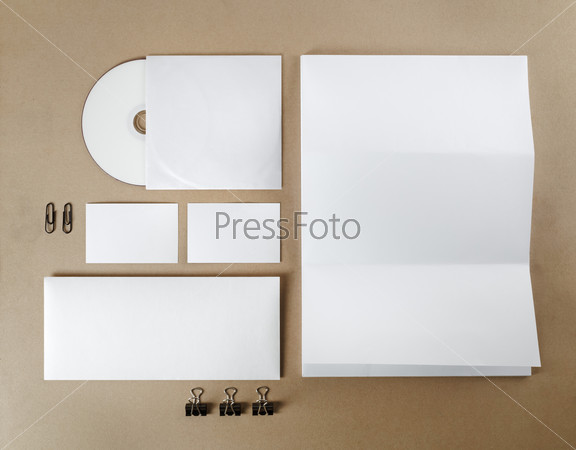 Photo of blank stationery and corporate identity template on kraft paper background.  For design presentations and portfolios. Top view.