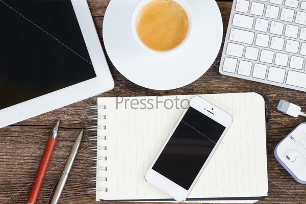 Top view office workplace - notebook with smartphone and frame of coffee, tablet and keyboard