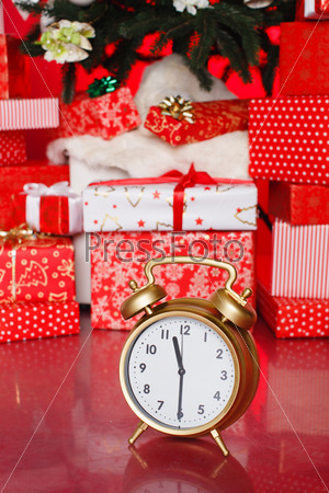 Christmas: big red gift box with red alarm clock - last minute christmas shopping