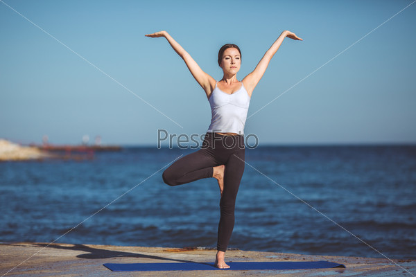 Healthy woman resting and curl up in fetal position outdoor at the sea yoga pose Series