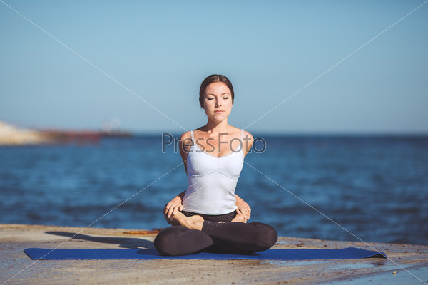 Healthy woman resting and curl up in fetal position outdoor at the sea yoga pose Series