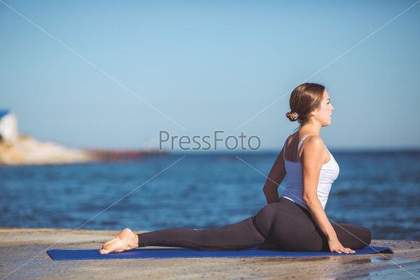 Healthy woman resting and curl up in fetal position outdoor\
at the sea yoga pose Series