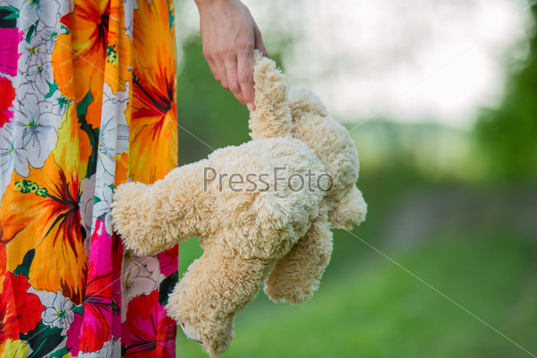 teddy bear is holding paw