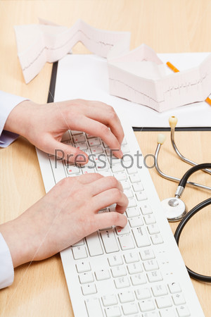 Medic works on white PC keyboard