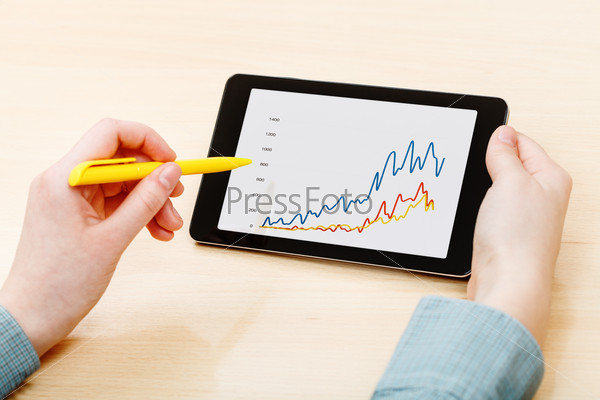 man touches by pen of tablet PC with business news