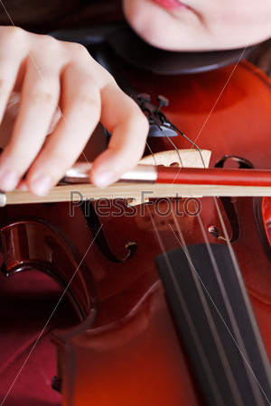 Girl playing violin - bow in arm and strings