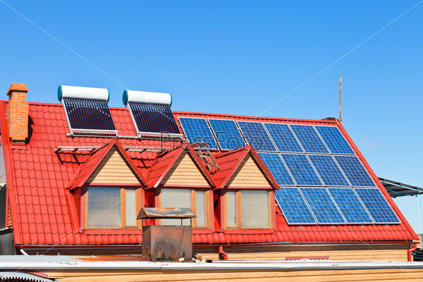 contemporary energy-saving technology - Solar Batteries and heaters on home roof
