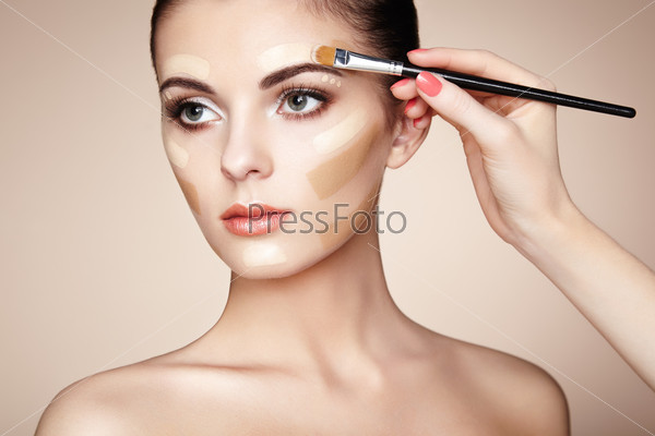Makeup artist applies skintone