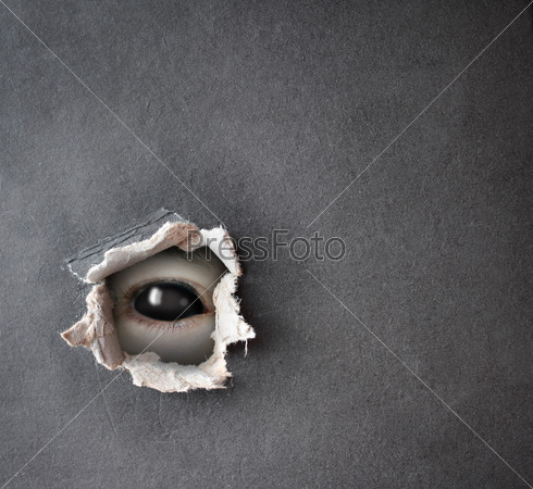 Dark series - a look from darkness. Monster eye in hole in the paper