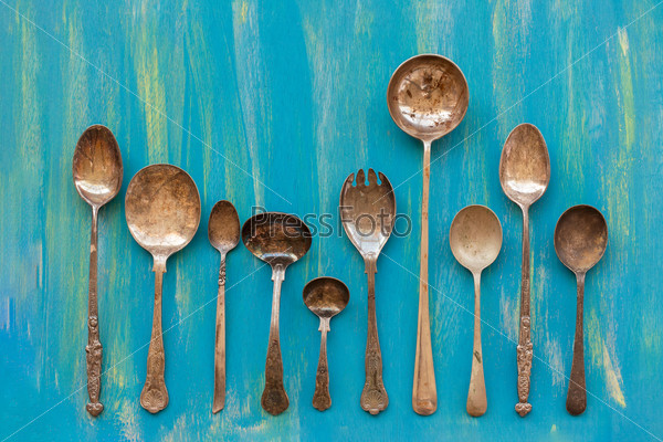 Old cutlery an blue wooden background, top view