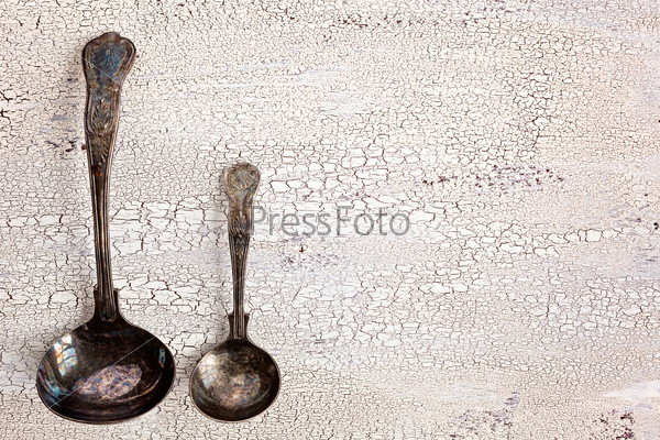 Old cutlery cracked white wooden background