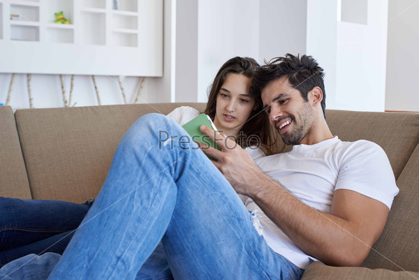 Couple at modern home using tablet computer