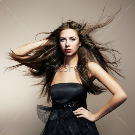 Portrait of young dancing woman with long flowing hair