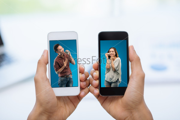 Hands holding smartphones with photos of couple talking via tin phone: communication concept