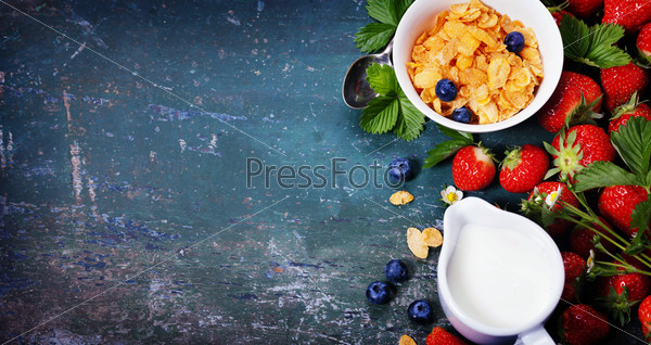 Breakfast with corn flakes, milk and strawberry