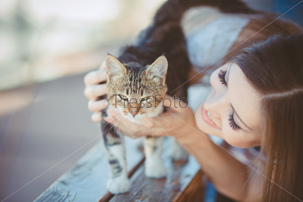 young woman with cat outdoors