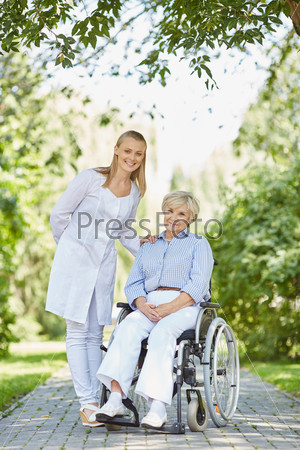 Nurse and senior woman in wheelchair