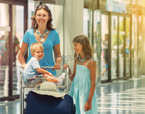 Young mother and child in the airport. Vintage toning