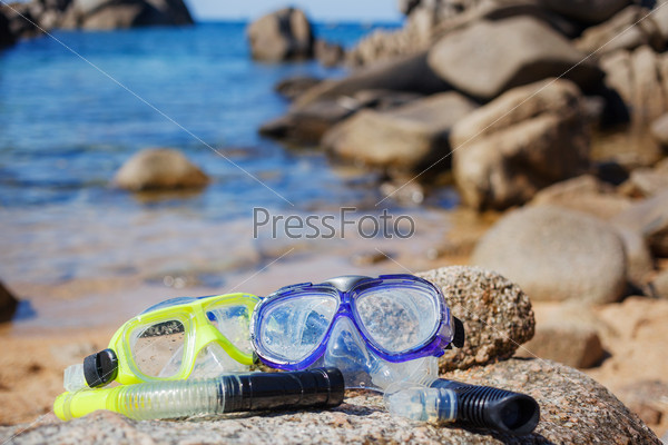 Diving goggles on sea beach