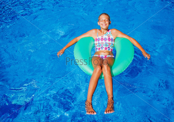 Girl swims in a pool