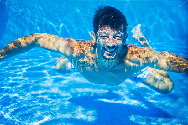 Man underwater in the pool, underwater photo