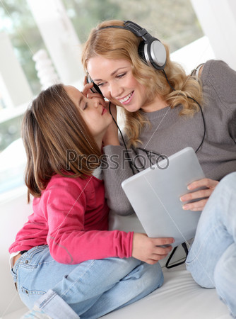 Mother and daughter listening to music