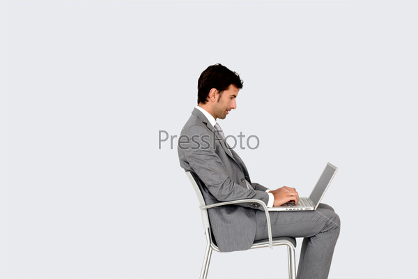 Businessman sitting on chair in front of laptop