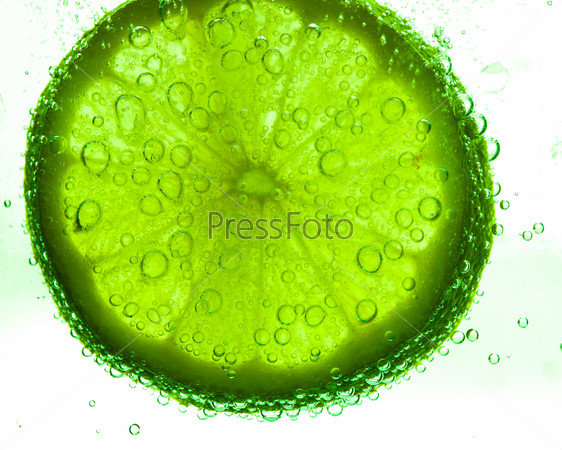 Slice of lime with water drops
