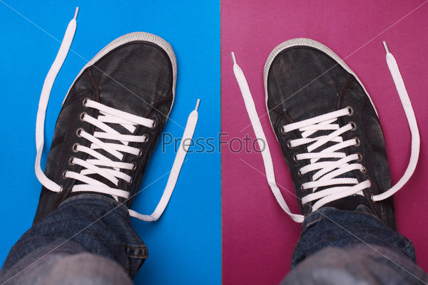 stylish blue gym shoes with white laces on a color background