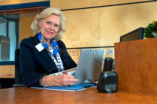 Smiling senior receptionist