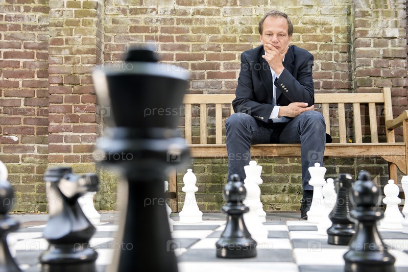 Man playing chess against computer - Stock Image - Everypixel