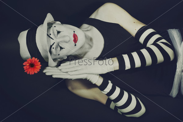 sleep mime in white hat with red flower on a black background