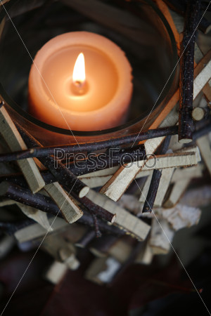 Candle in wooden candle holder, view from above