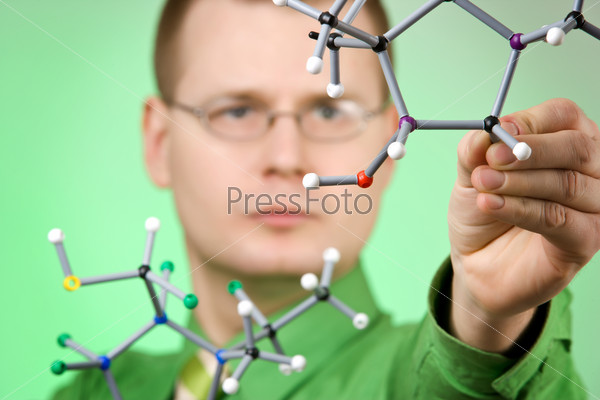 close up portrait of young chemist, developing new molecular structures. focus on molecule
