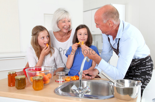 Grandparents cooking with kids in home kitchen