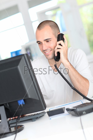 Smiling man answering the phone