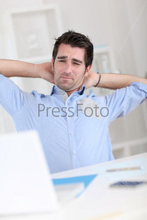 Office worker stretching arms at work