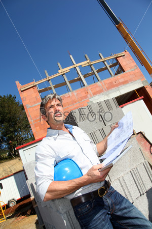 Entrepreneur on building site with tablet