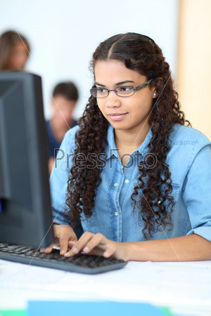 Portrait of teenager in computing class