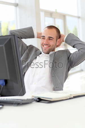 Portrait of relaxed salesman in office