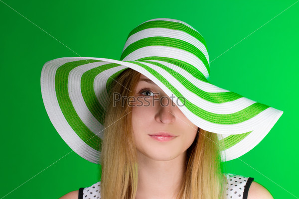 Girl in a green hat the beach strip. horizontal
