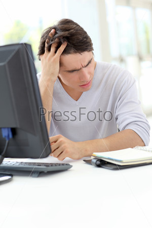 Portrait of office worker having a headache at work