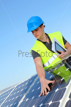 Young adult doing professional training on solar panels plant