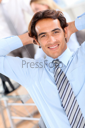 Smiling relaxed businessman in office
