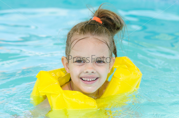 Portrait of smiling girl in a swimming pool