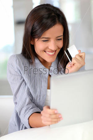 Young woman doing online shopping with tablet