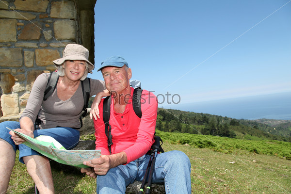 Senior couple looking at map on hiking day